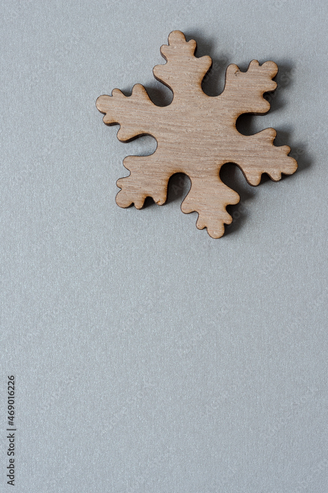 wooden christmas snowflake on gray-silver paper wooden christmas snowflake on gray-silver paper