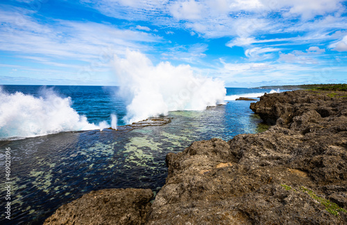 A beautiful view of the spectacular coastal blowholes that are an important tourist attraction on the Pacific Island nation of Tonga, on a beautiful sunny day. photo
