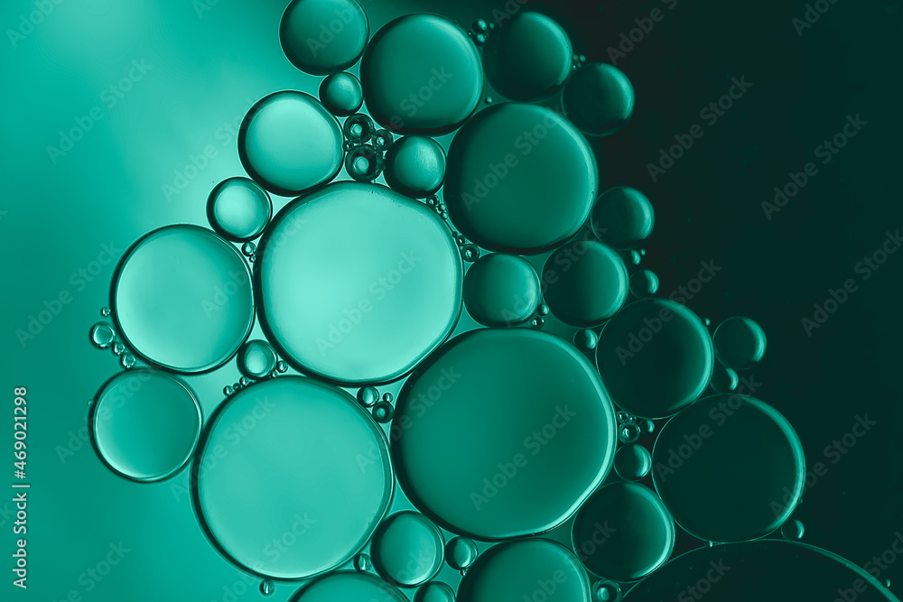 Pattern formed by a beautiful collection of bubbles created by oil droplets on the surface of water and highlighted with metallic green lighting Pattern formed by a beautiful collection of bubbles created by oil droplets on the surface of water and highlighted with metallic green lighting