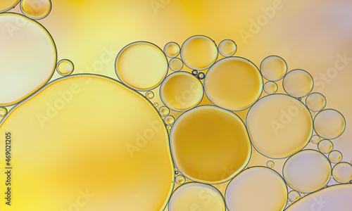 Oil buuble on golden light effects background.