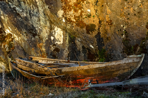 Old, rustic wooden boat blending in. photo