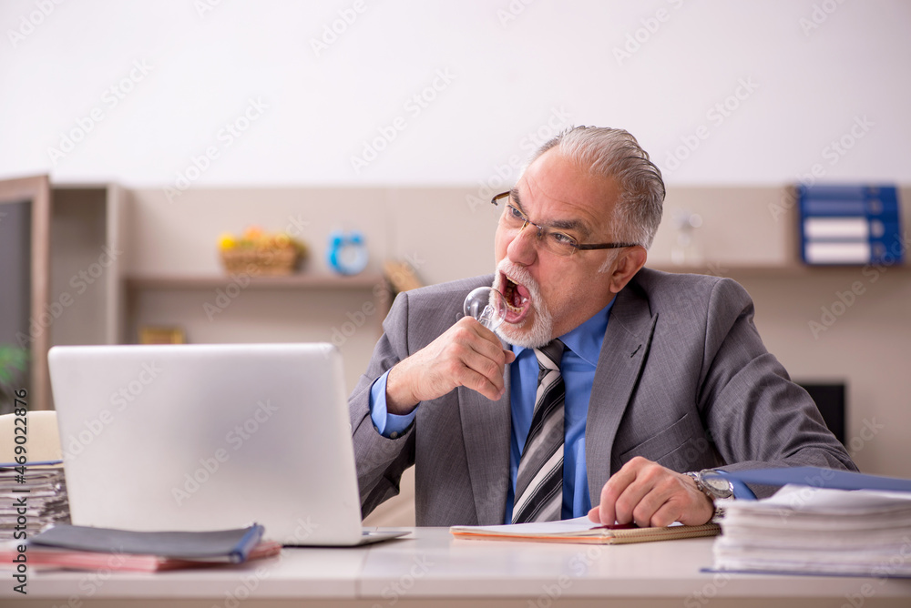 Old male employee in happy idea concept during pandemic Old male employee in happy idea concept during pandemic