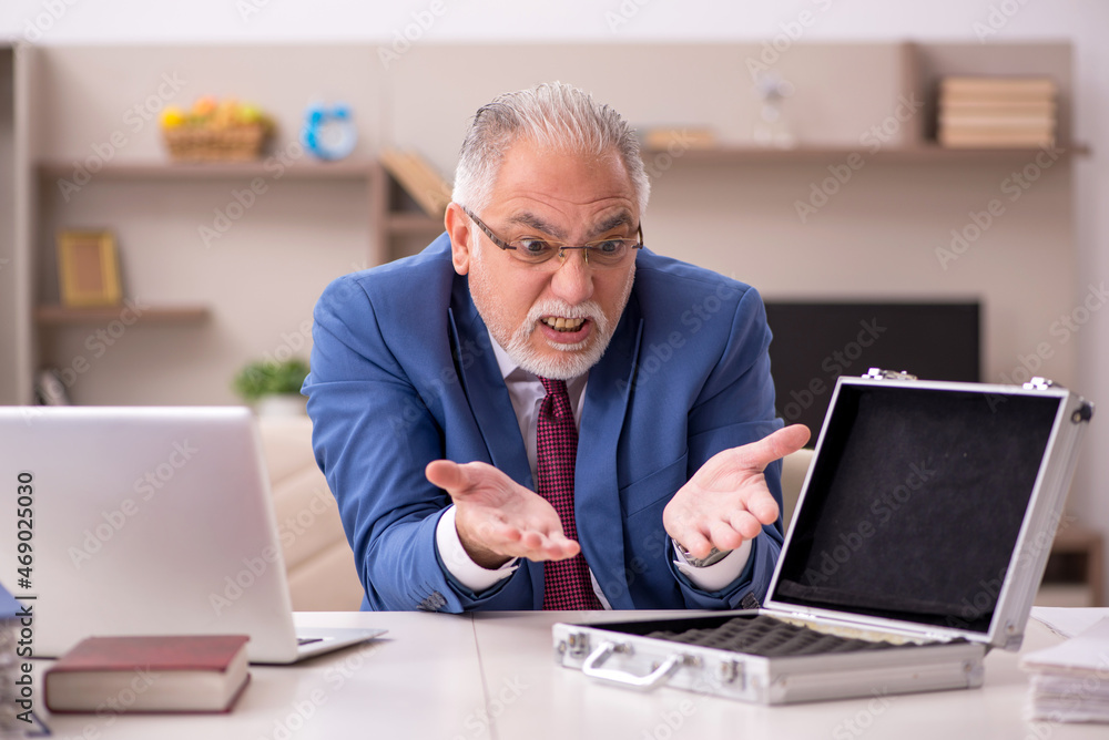 Old male employee and empty money case at home Old male employee and empty money case at home