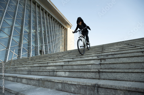 Woman freerider riding down city stairs