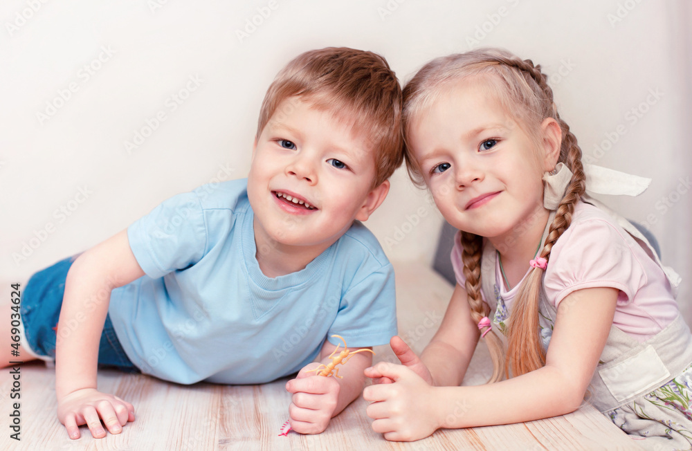 A boy and a girl are smiling at the kitchen table A boy and a girl are smiling at the kitchen table