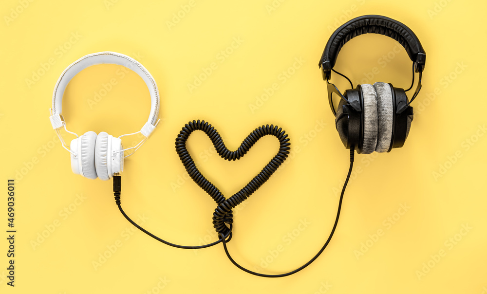 Flat lay musical background with black and white headphones. Flat lay musical background with black and white headphones.