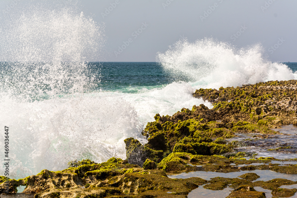 view from the beaches of oman sea in chabahar, baluchistan province, iran. waves hitting the rocks on the beach