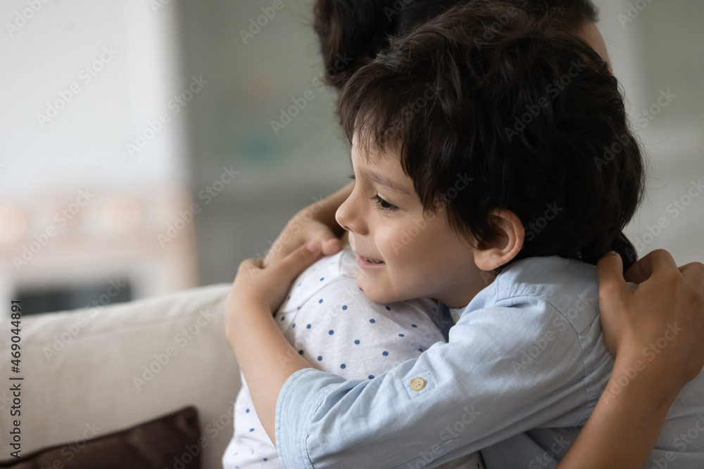 Happy Indian preschool boy embracing beloved mom with love, affection, trust. Young mother and little son enjoying friendship, unity, close relationship, embracing, smiling. Childhood, family Happy Indian preschool boy embracing beloved mom with love, affection, trust. Young mother and little son enjoying friendship, unity, close relationship, embracing, smiling. Childhood, family
