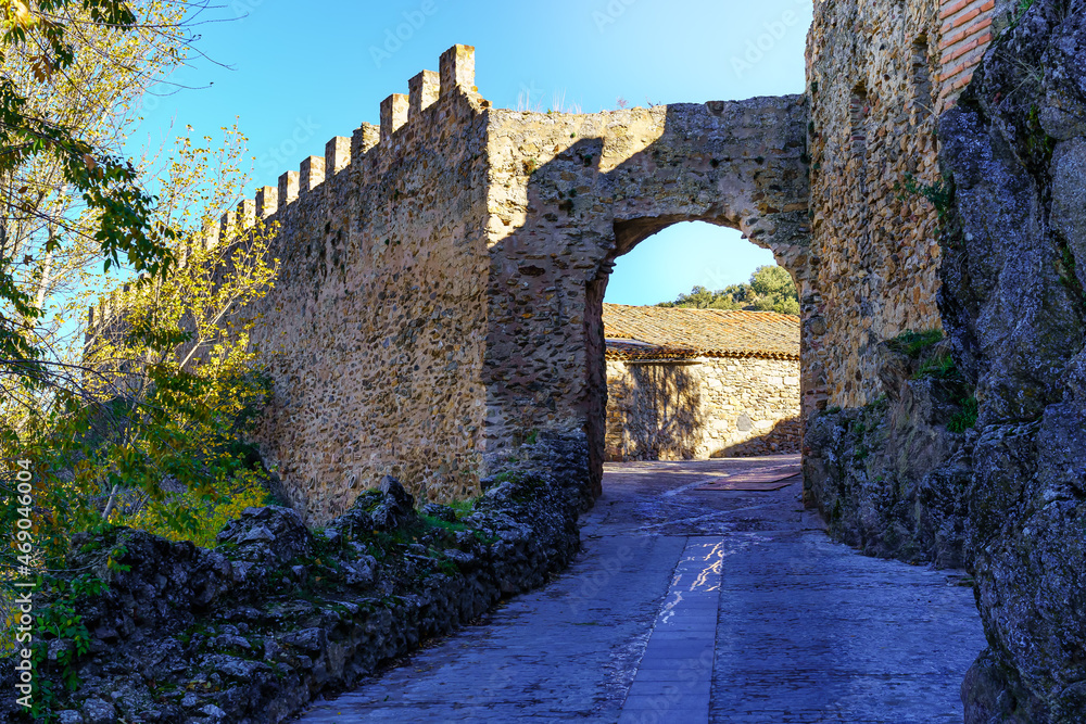 Medieval stone wall with arched doorway. Buitrago de Lozoya Madrid.
