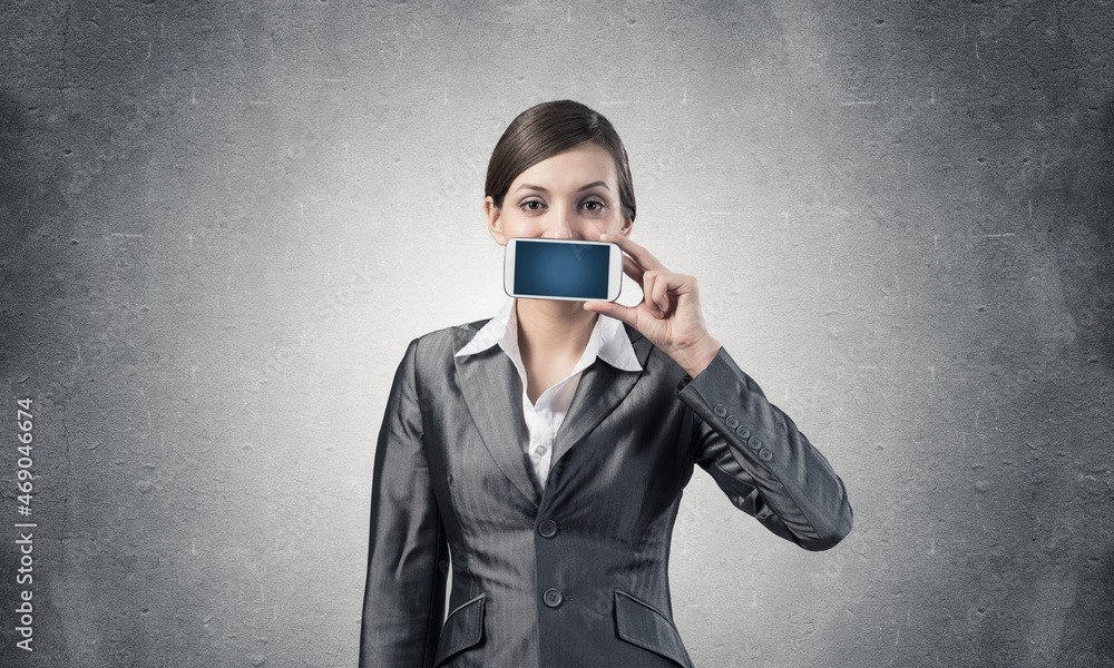 Woman covering her mouth with smartphone Woman covering her mouth with smartphone