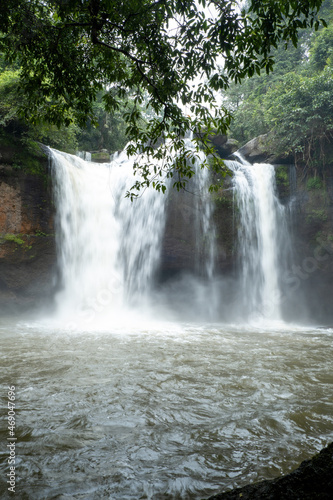 People watch the beautiful nature with trees and mountains  waterfalls. It is a tourist destination for a vacation.