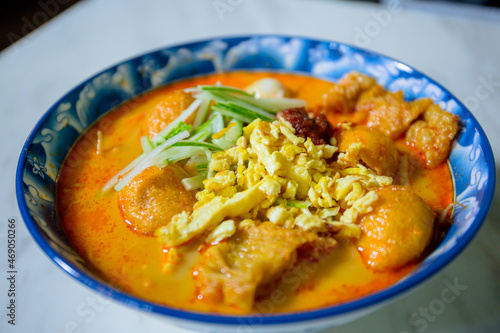Laksa is a spicy noodle soup popular in the Peranakan cuisine of Southeast Asia. It served with a prawns, fish cake, fish balls and shredded egg. 