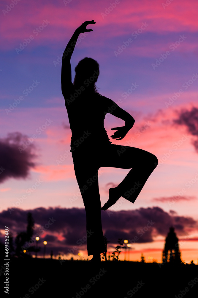 silhouette from a ballet dancer during the dusk or sunset happy positive motion with music 