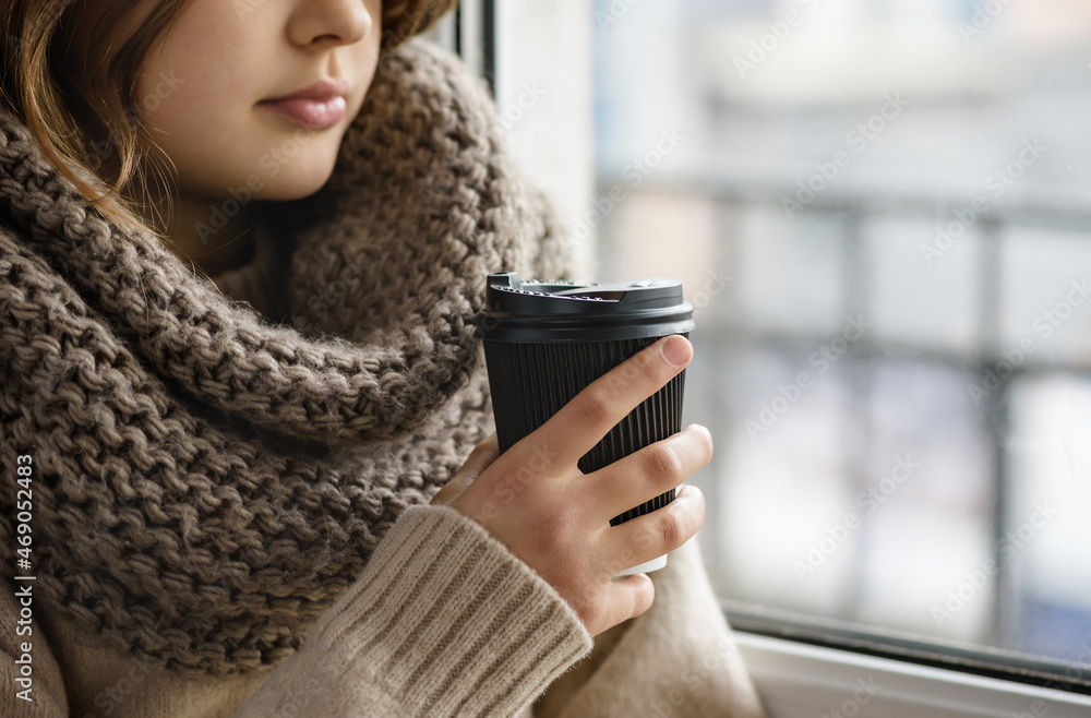 Girl is holding a paper cup with coffee. Girl is holding a paper cup with coffee.