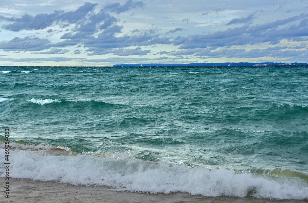 a stunning view across the turquoise-colored water of lake michigan from the beach at sleeping bear point in sleeping bear dunes national lakeshore in the lower peninsula of michigan