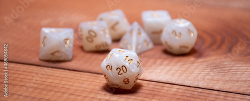 Set of role playing white dices on a gaming table made of wood: banner for role-playing games with place for text