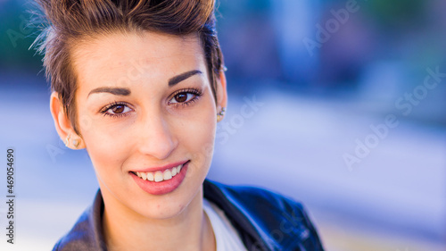 headshot froma a yooung hispanic female. Beautiful woman with an ambiguous hairsyling photo