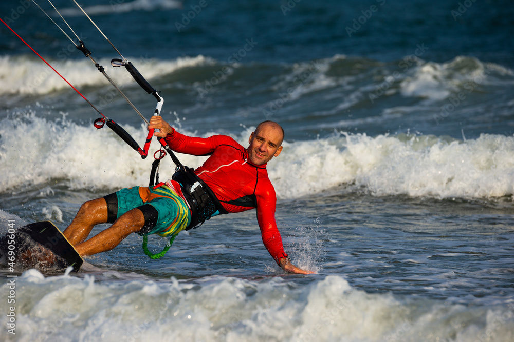 Naklejka premium Kitesurfing on the waves of the sea in Mui Ne beach, Phan Thiet, Binh Thuan, Vietnam. Kitesurfing, Kiteboarding action photos.