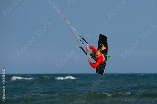 Kitesurfing on the waves of the sea in Mui Ne beach, Phan Thiet, Binh Thuan, Vietnam. Kitesurfing, Kiteboarding action photos. 