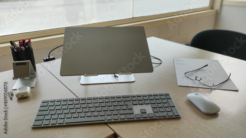 Laptop computer on a work table in an unmanned office