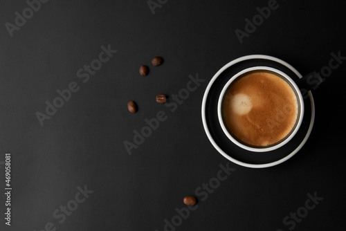 Cup of coffee on black background. Modern Lifestyle Flat-lay Top-down Minimalist Flat-lay. Top view. Copy space.