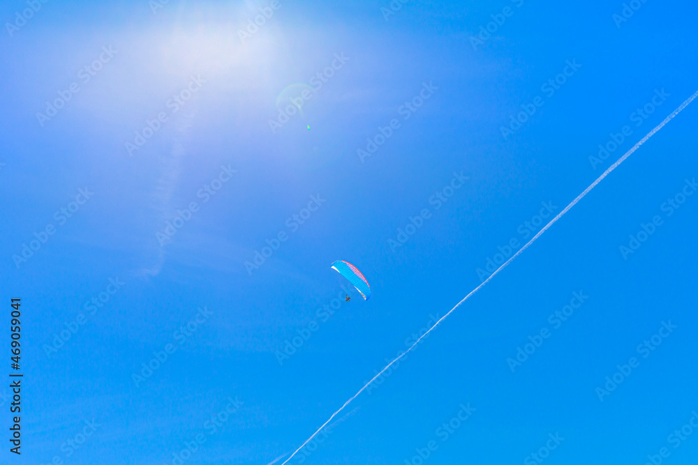 Mountain paragliding in the blue sky of Aroser Weisshorn peak, tourist resort in Switzerland in Grisons Canton.