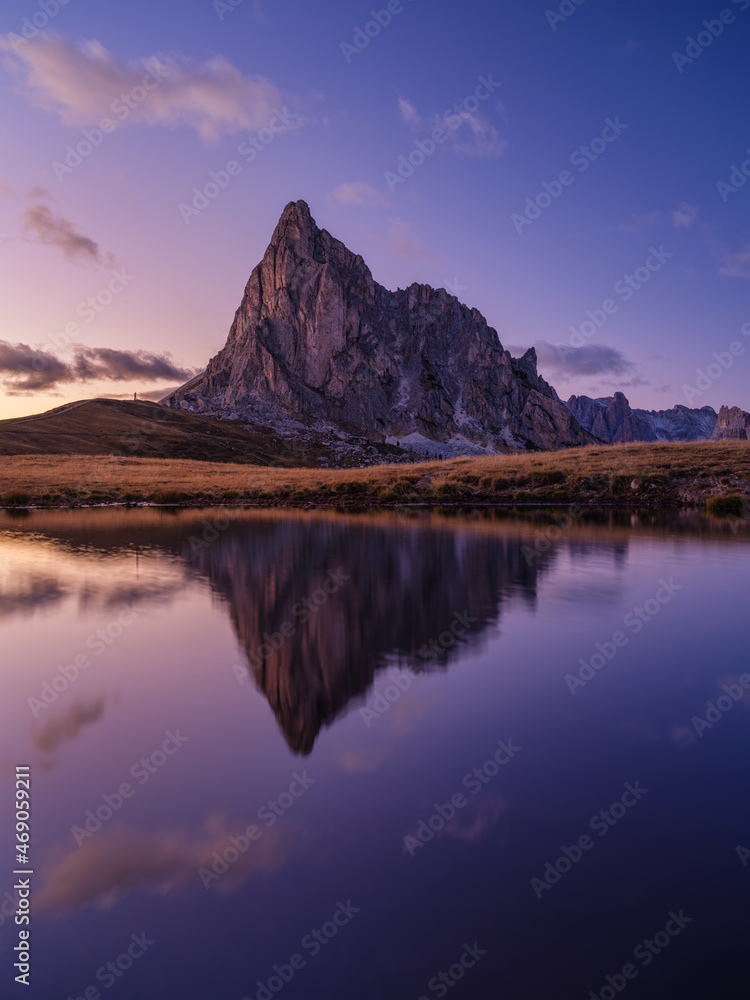 High mountains and reflection on the surface of the lake. Giau Pass, Dolomite Alps, Italy. Landscape in the highlands during sunset. Photo in high resolution.