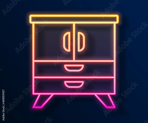 Glowing neon line Chest of drawers icon isolated on black background. Vector