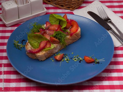 bruschetta with salmon gravlax on a blue plate in a restaurant photo