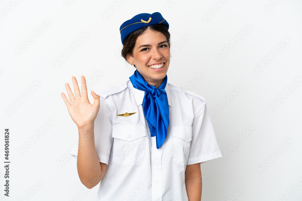 Airplane stewardess caucasian woman isolated on white background saluting with hand with happy expression Airplane stewardess caucasian woman isolated on white background saluting with hand with happy expression