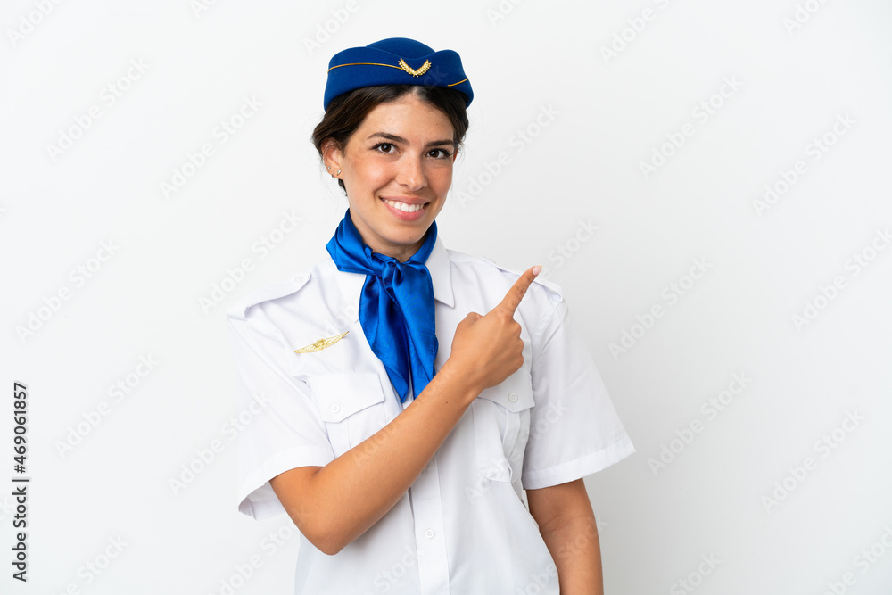 Airplane stewardess caucasian woman isolated on white background pointing to the side to present a product Airplane stewardess caucasian woman isolated on white background pointing to the side to present a product