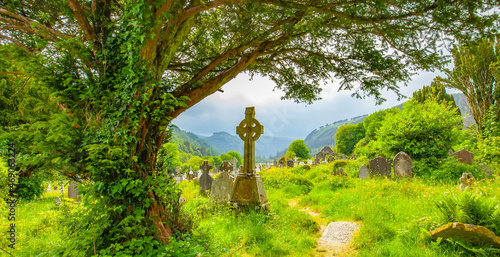 Celtic cross in old Irish graveyard in Glendalough, Ireland photo