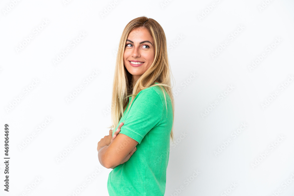 Blonde Uruguayan girl isolated on white background with arms crossed and happy Blonde Uruguayan girl isolated on white background with arms crossed and happy