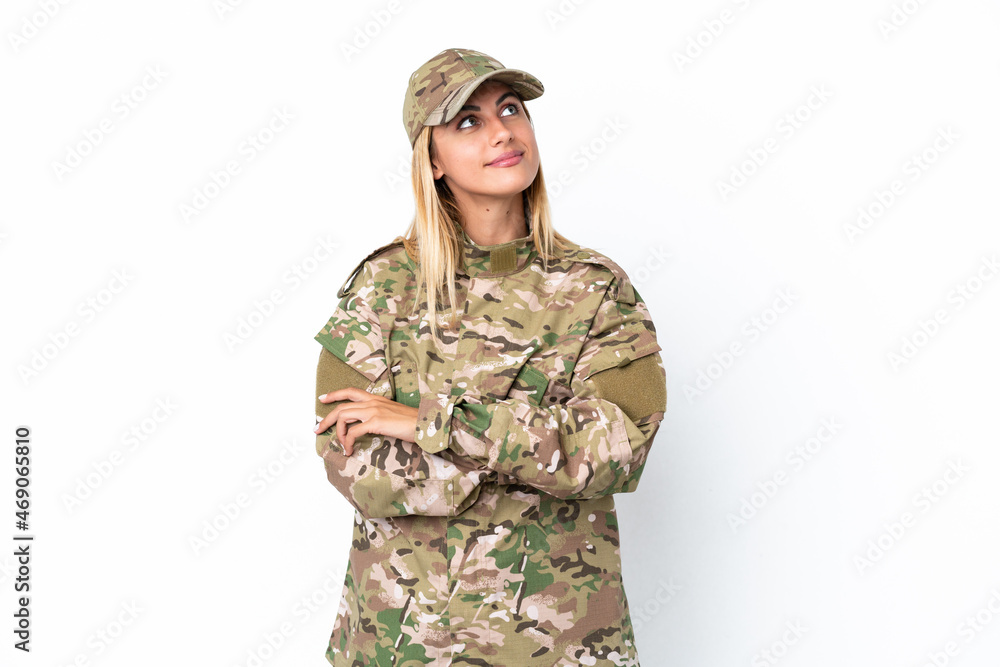 Military woman isolated on white background looking up while smiling Military woman isolated on white background looking up while smiling