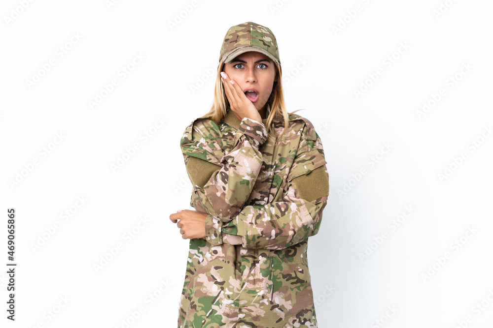 Military woman isolated on white background surprised and shocked while looking right
