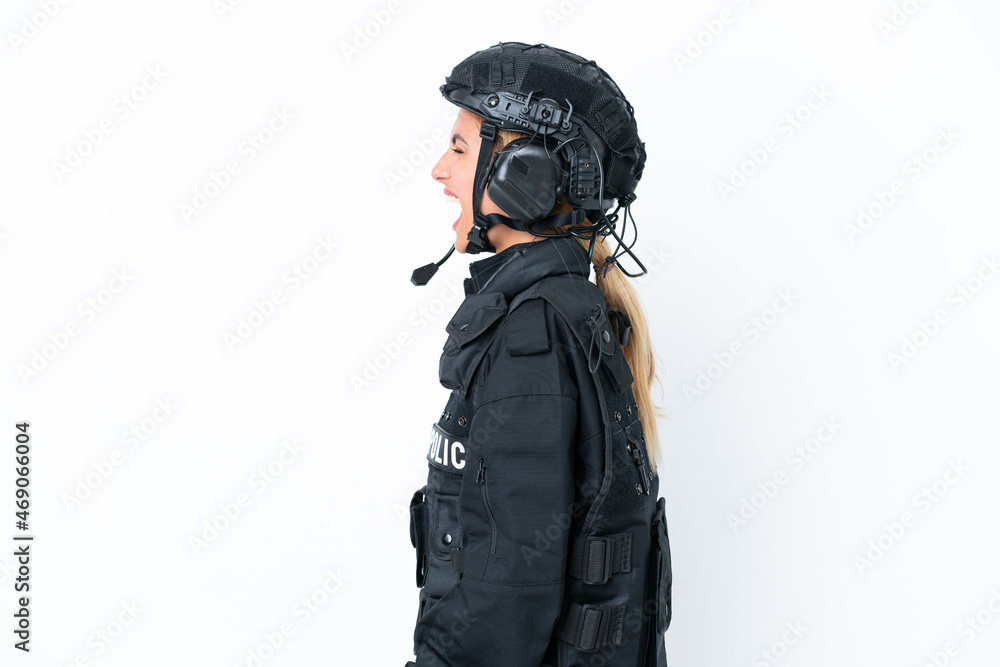 SWAT caucasian woman isolated on white background laughing in lateral position SWAT caucasian woman isolated on white background laughing in lateral position