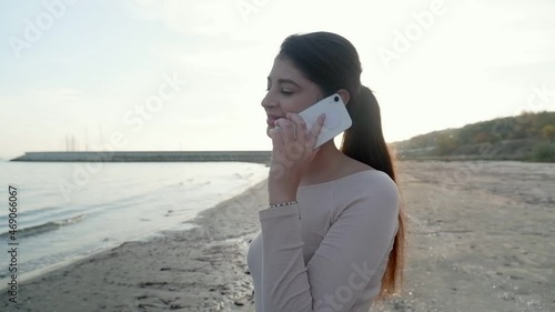 rejoicing and smiling young girl on the beach, sunset time.