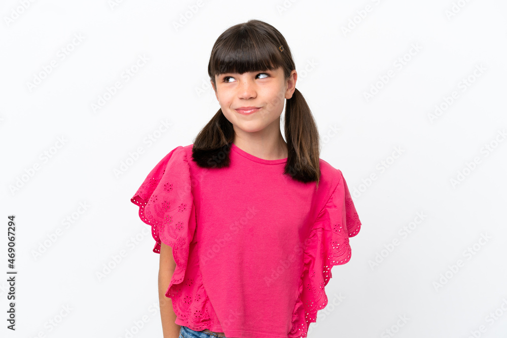 Little caucasian kid isolated on white background making doubts gesture looking side Little caucasian kid isolated on white background making doubts gesture looking side