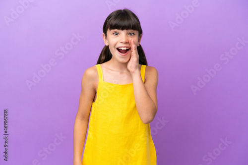 Little caucasian kid isolated on purple background with surprise and shocked facial expression