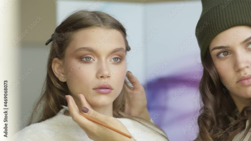 Makeup artist makes makeup for a beautiful model. Makeup artist makes makeup for a beautiful model.