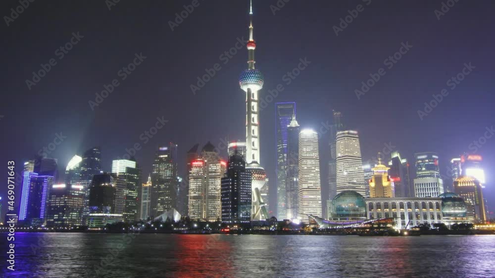 Time lapse of Shanghai skyline and tour boat at night - zoom out Time lapse of Shanghai skyline and tour boat at night - zoom out