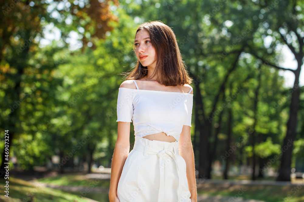 Young beautiful brown-haired girl with freckles on her face Young beautiful brown-haired girl with freckles on her face