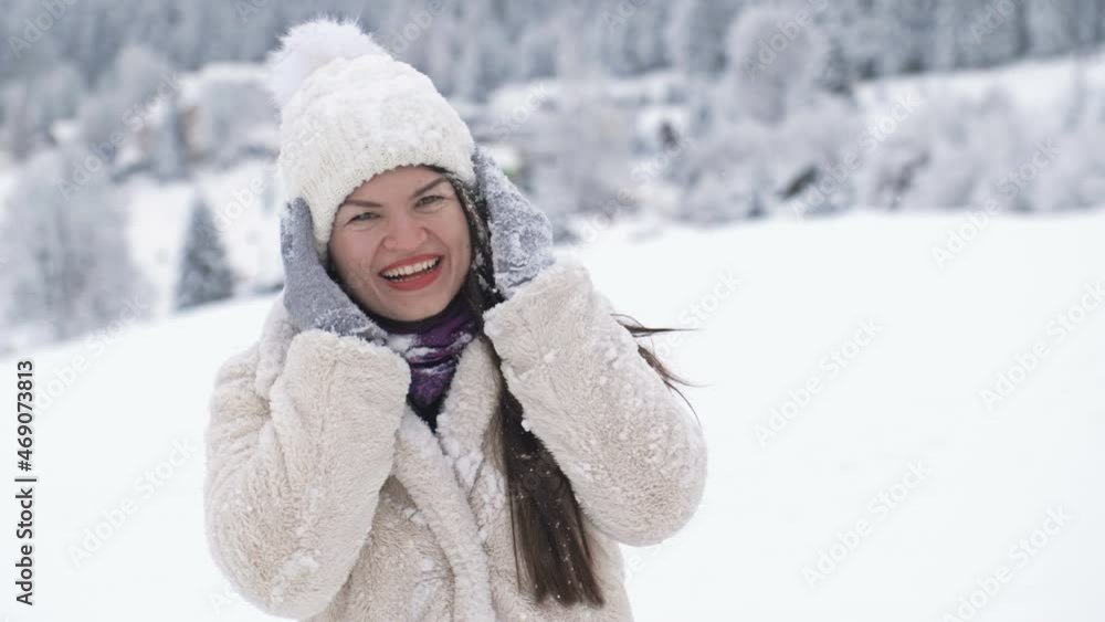 Young woman stands on a balcony with a beautiful view of the sea and mountains. Woman gladly exposes her face to the rays of the sun. Young woman stands on a balcony with a beautiful view of the sea and mountains. Woman gladly exposes her face to the rays of the sun.