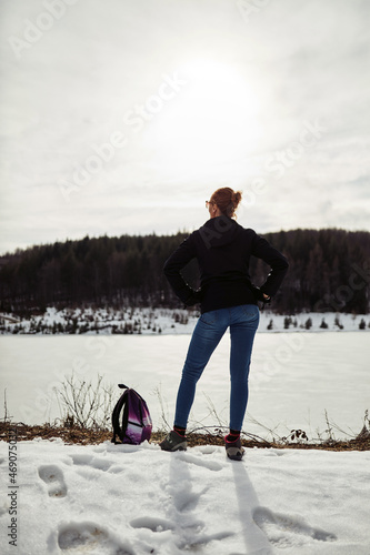 Woman enjoying on a mountain winter fresh air. photo