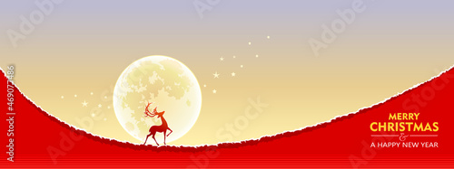 A beautiful silhouette of a reindeer, a magnificent moon in the background, and glittering stars. Greeting card for Christmas wishes.