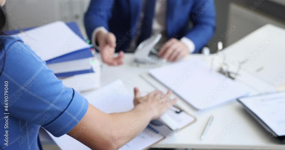Man and woman sorting documents with stapler and hole punch and folding into folders 4k movie slow motion Man and woman sorting documents with stapler and hole punch and folding into folders 4k movie slow motion