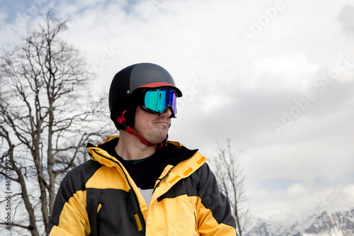 Portrait of a male snowboarder in a helmet and goggles