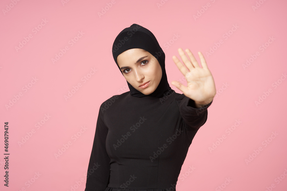 cheerful muslim woman black hijab posing hand gesture pink background cheerful muslim woman black hijab posing hand gesture pink background