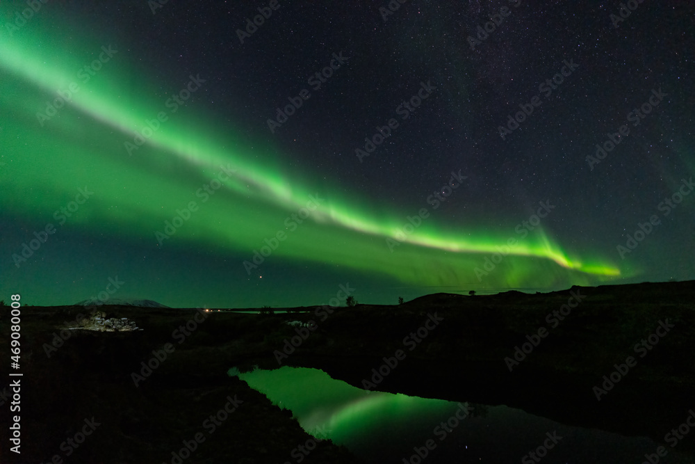 Aurora borealis lights reflected over the lake