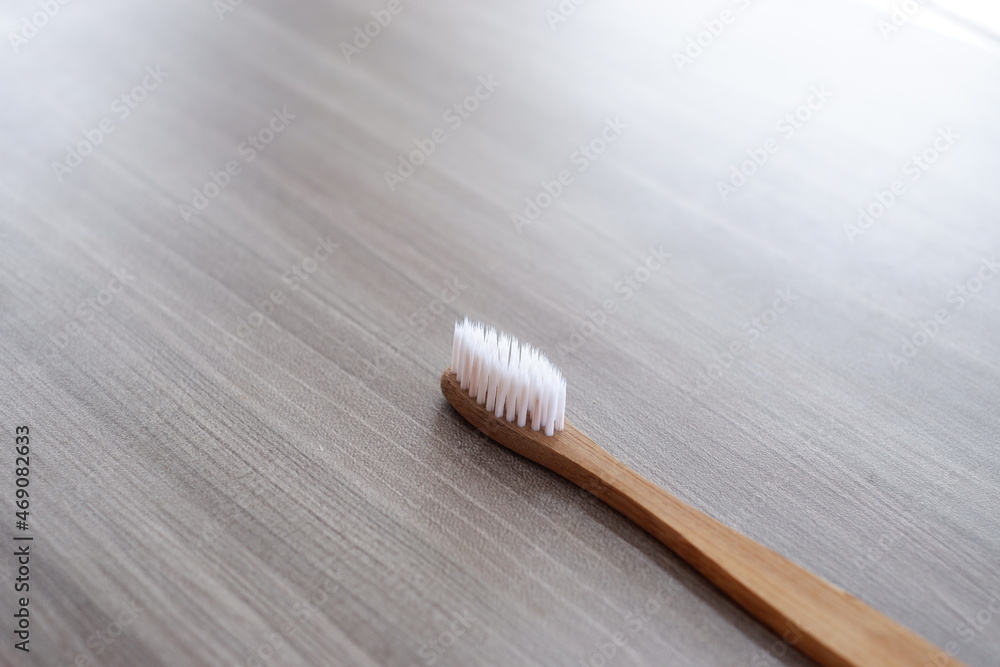 Close-up photo of a toothbrush against a wood texture background from various angles Close-up photo of a toothbrush against a wood texture background from various angles